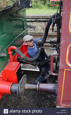 the-driver-of-a-steam-engine-couples-the-vacuum-brake-pipe-of-the-BR42CK.jpg