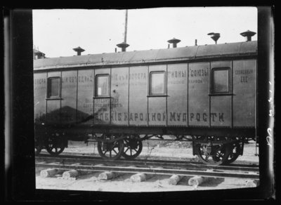 A war of words. The war in South Russia is fought as much with tongue and pen as with sword and rifle. Each army has its well equipped staff of propagandists who follow close in the rear of the fighting troops with posters and literature telling of the wonderful results that will be gained through a support of their army. Special army railroad cars are equipped with propaganda material. This picture shows one of the cars of this type used by the Volunteer Army. When the American Red Cross wished to send two car loads of medical supplies into a recently captured town the only transportation they could get was to couple their relief cars to the propaganda train. It went into the city ahead of food or ammunition trains, for successful propaganda is one of the most important parts of warfare according to the Russian mind